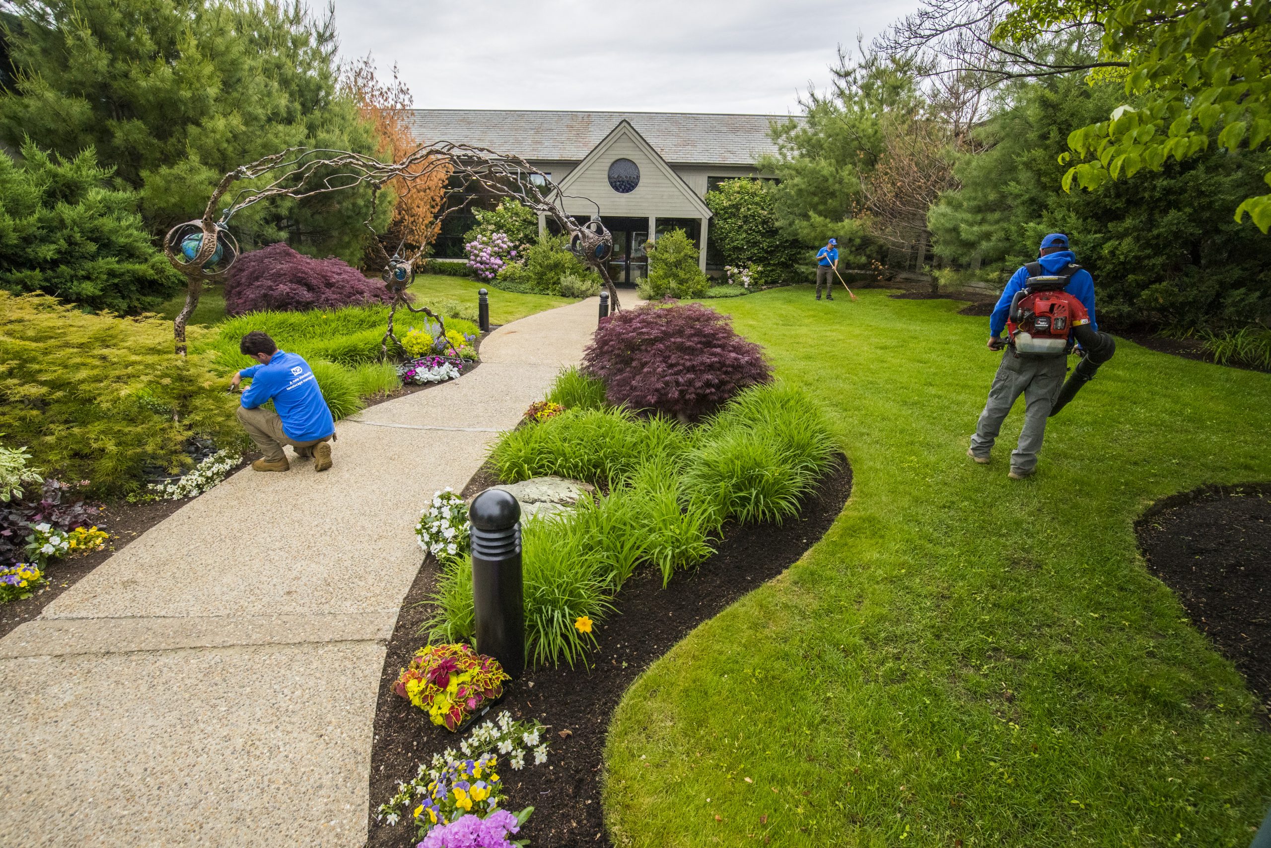 curved garden and path with landscapers